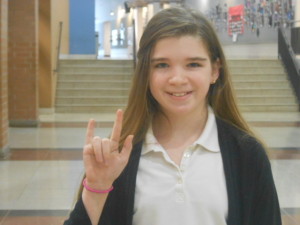 Sabrina Wilson, a 6th grader, signs I love you.